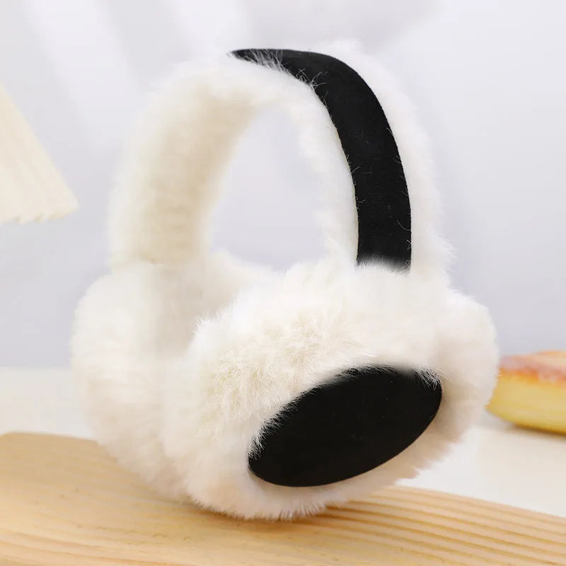 Black winter earmuffs with fluffy white faux fur and black suede patch details