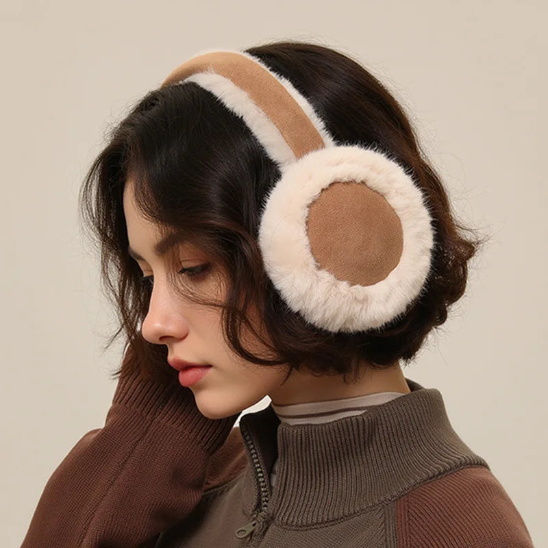 Model in khaki winter earmuffs with soft cream faux fur, styled with a knit jacket