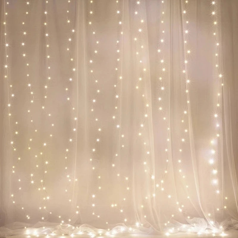 Soft white fairy lights for bedroom hanging as vertical strands behind sheer white drapes