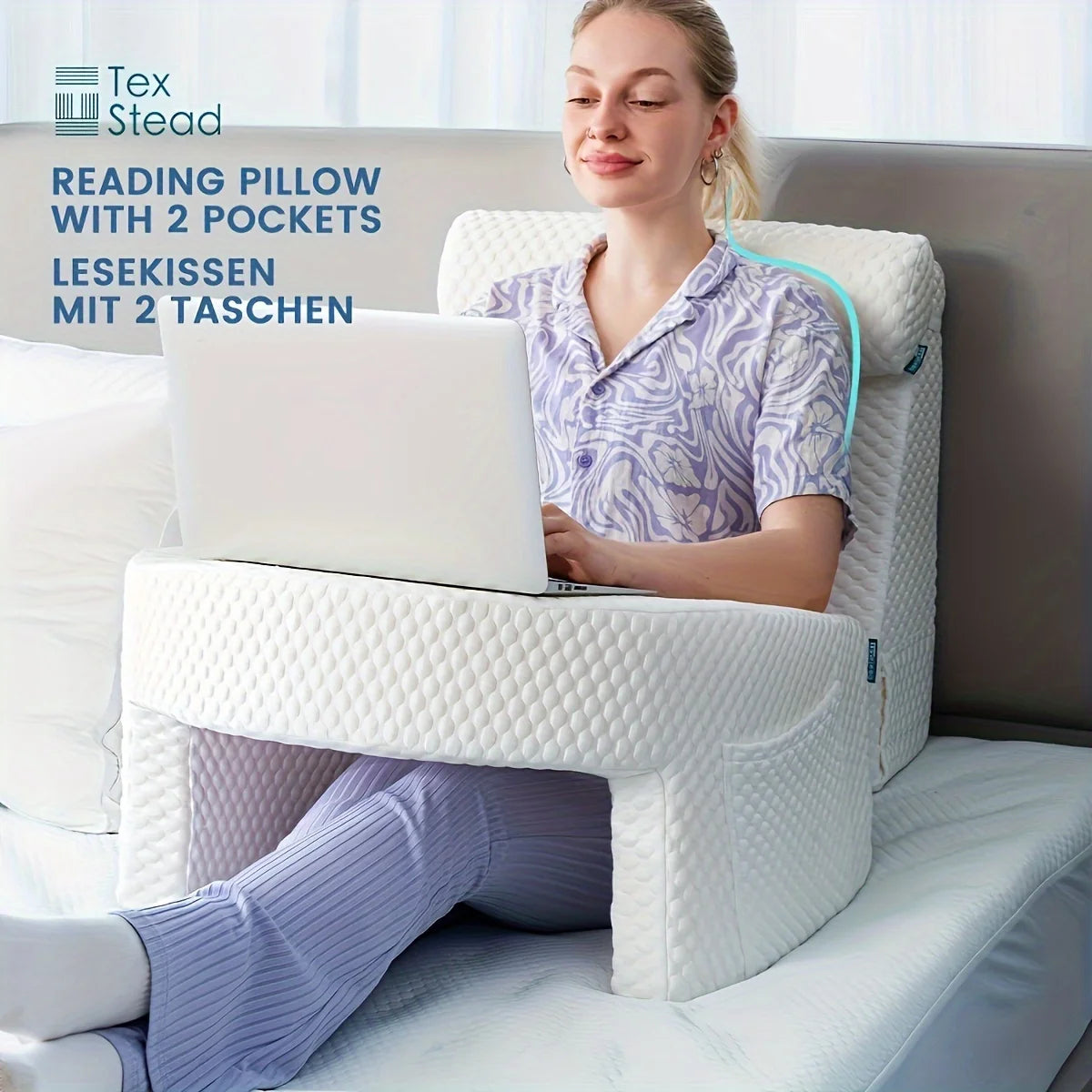 Woman using a laptop on a reading pillow with two pockets on a couch.