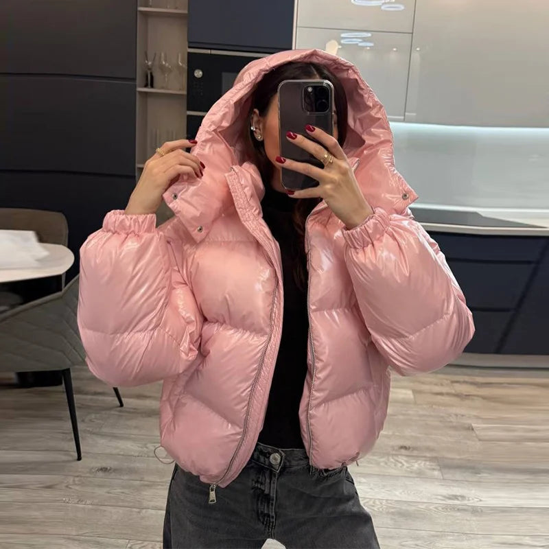 Woman wearing the Pink hooded cropped bubble puffer jacket with hood up