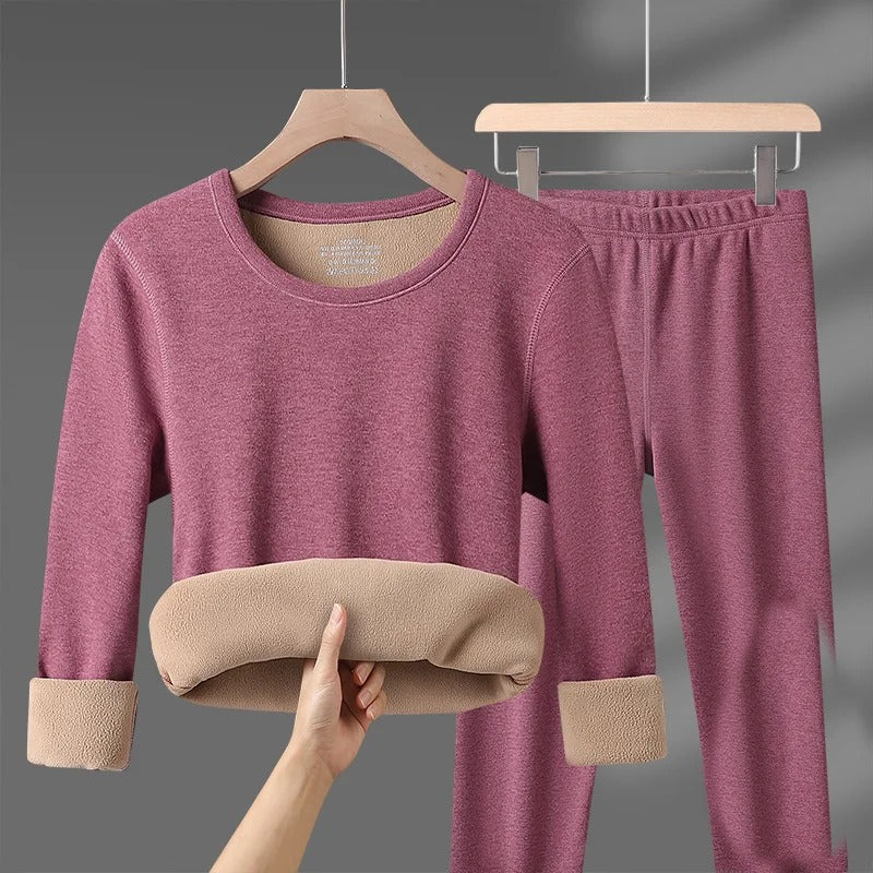 Women's pink fleece-lined thermal underwear set, top and pants on hangers