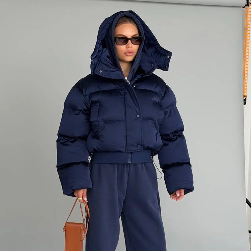 Woman wearing the Navy hooded cropped bubble puffer jacket with hood up