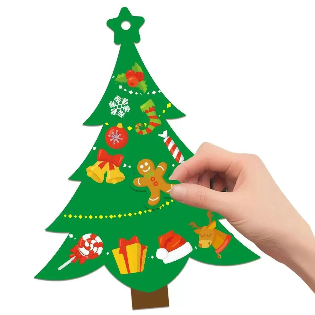 Hand pressing a gingerbread man sticker onto a green Christmas tree cut-out